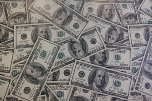 a pile of hundred doller bills